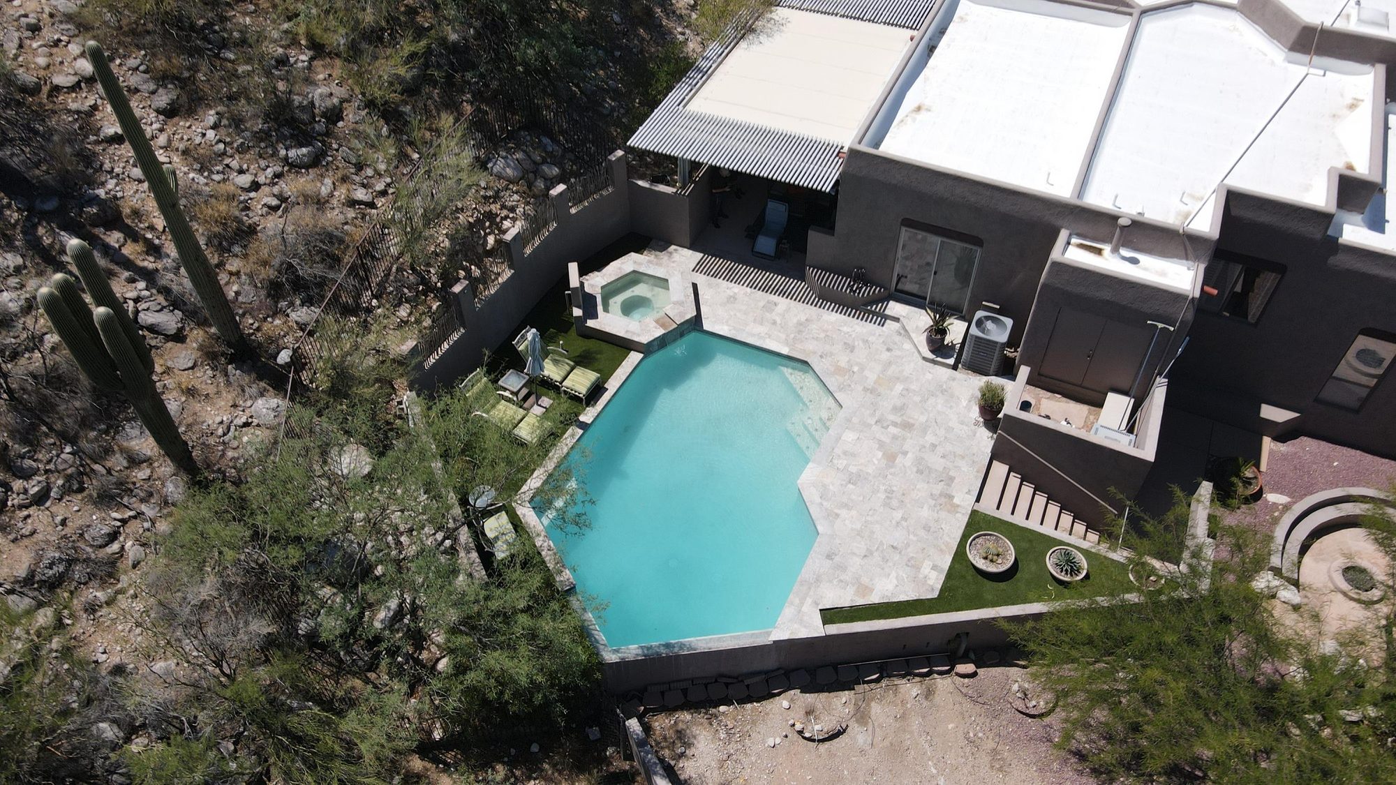 Aerial view of a custom desert pool, spa, and travertine patio in Tucson by Sorce Signature Outdoors