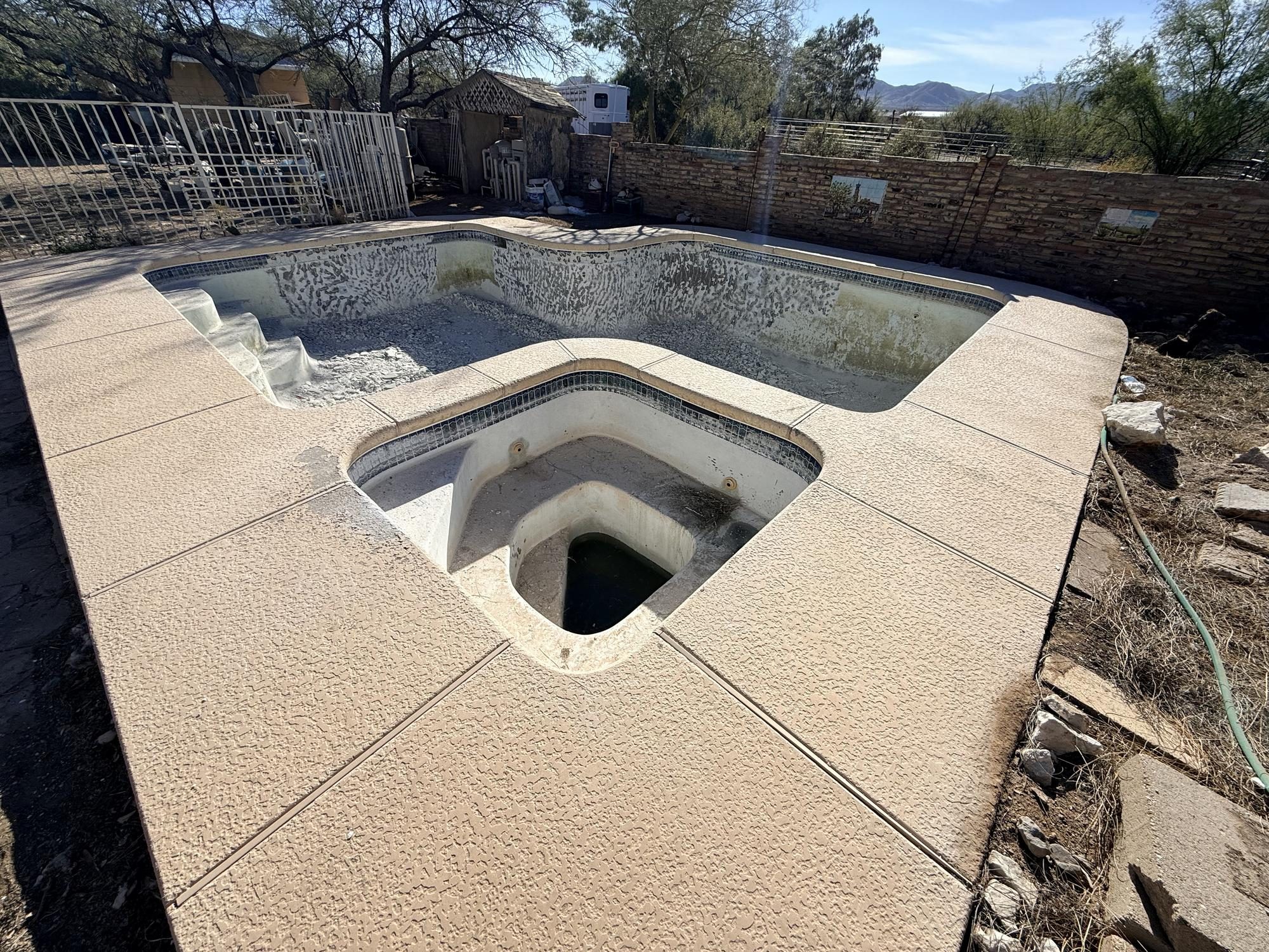 Before: abandoned concrete pool with spa