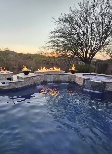 Sunset pool with fire bowls and water features in Tucson by Sorce Signature Outdoors